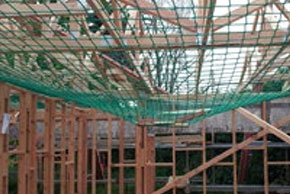 [image] View beneath a safety net containing debris